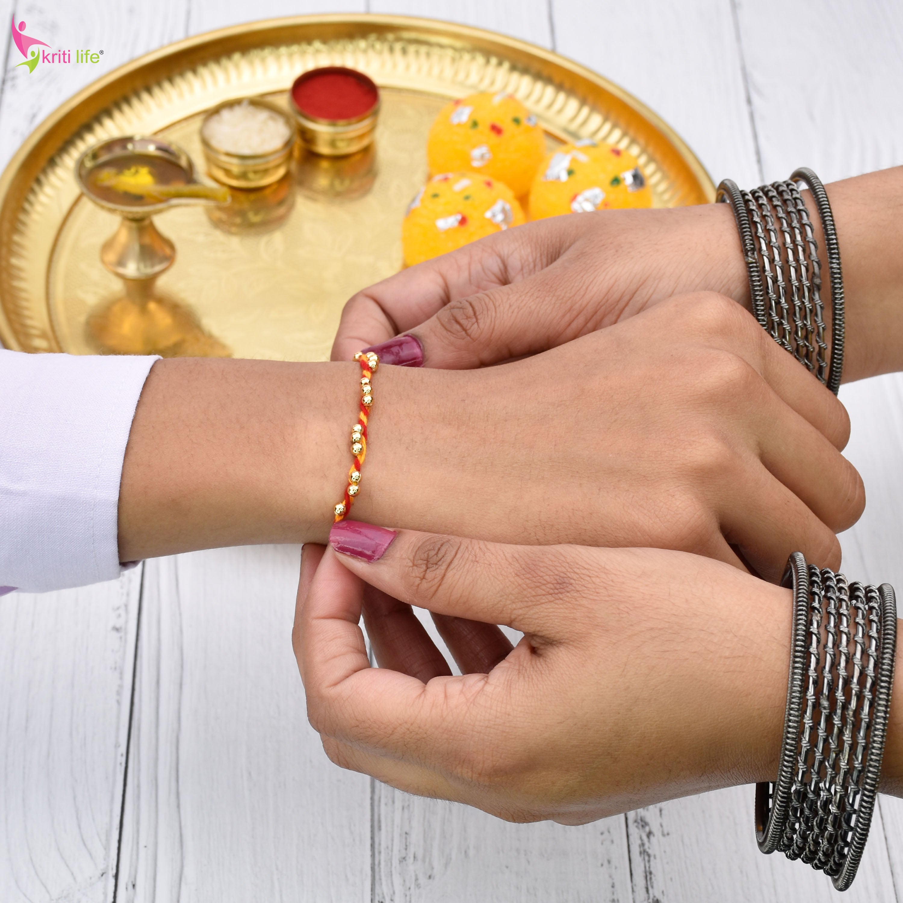 Traditional Mouli Thread Rakhi Set of 2 with Golden Beads