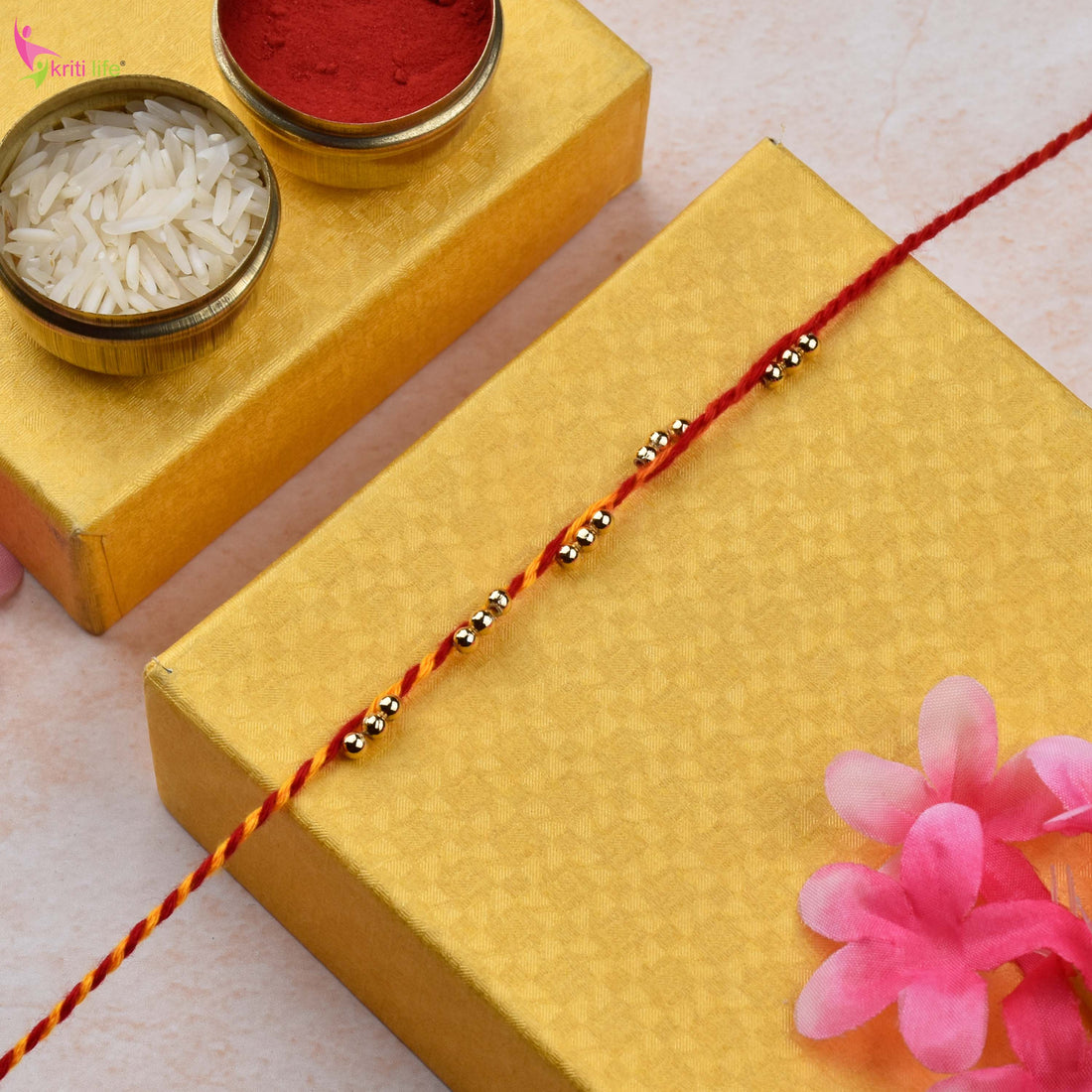 Traditional Mouli Thread Rakhi Set of 2 with Golden Beads
