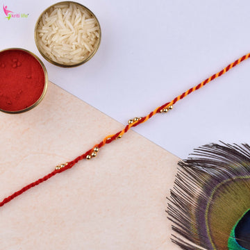 Traditional Mouli Thread Rakhi Set of 2 with Golden Beads